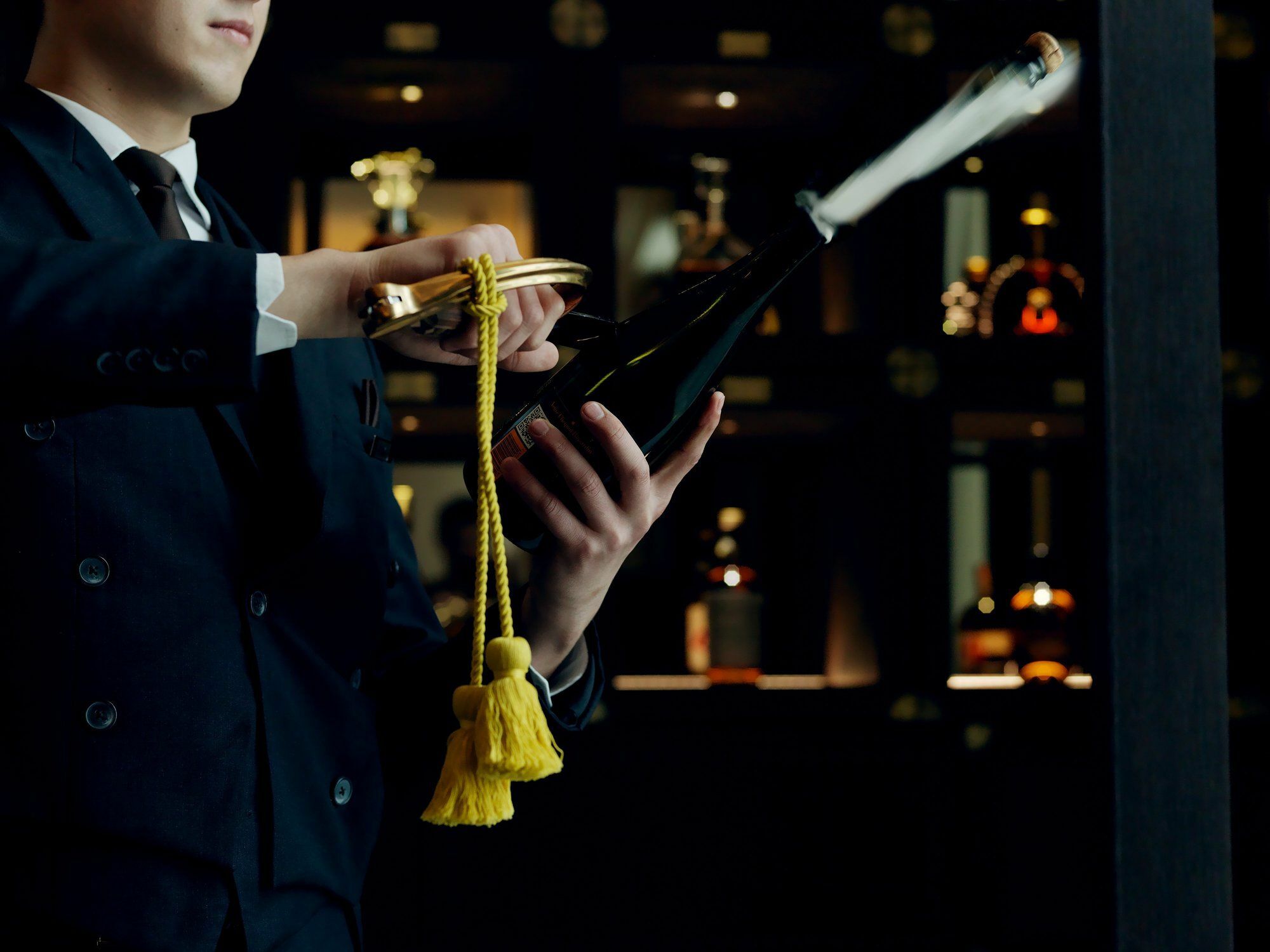 Отель The St. Regis Astana Экстерьер фото A wine waiter opening a bottle of wine